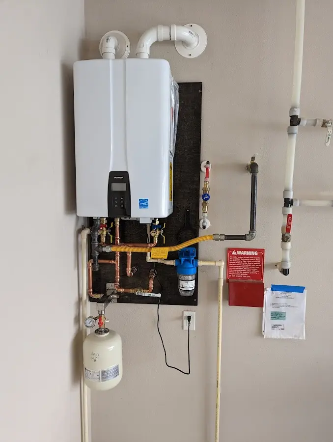 Professional plumber installing copper piping in a Virginia Beach home